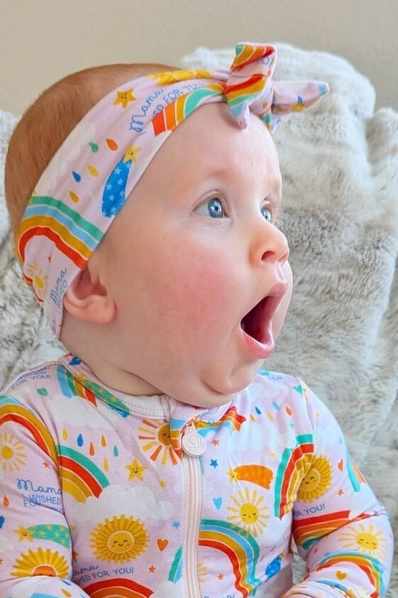 Baby girl looking off to the side with an expression of wonderment