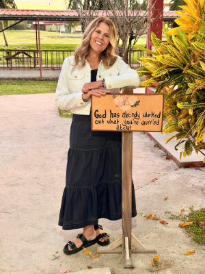 Mary Beth Boettcher standing; facing camera and smiling