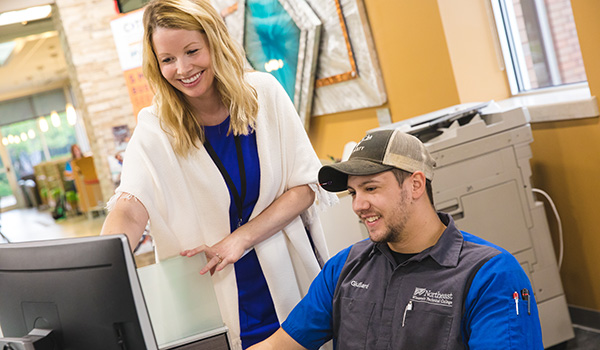 An academic advisor works with a student in the welcome center