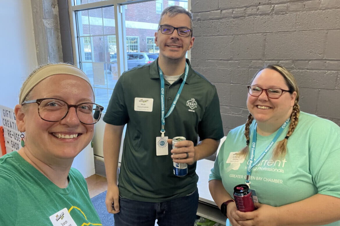 Matt Kaczmarek stands with two other art project volunteers