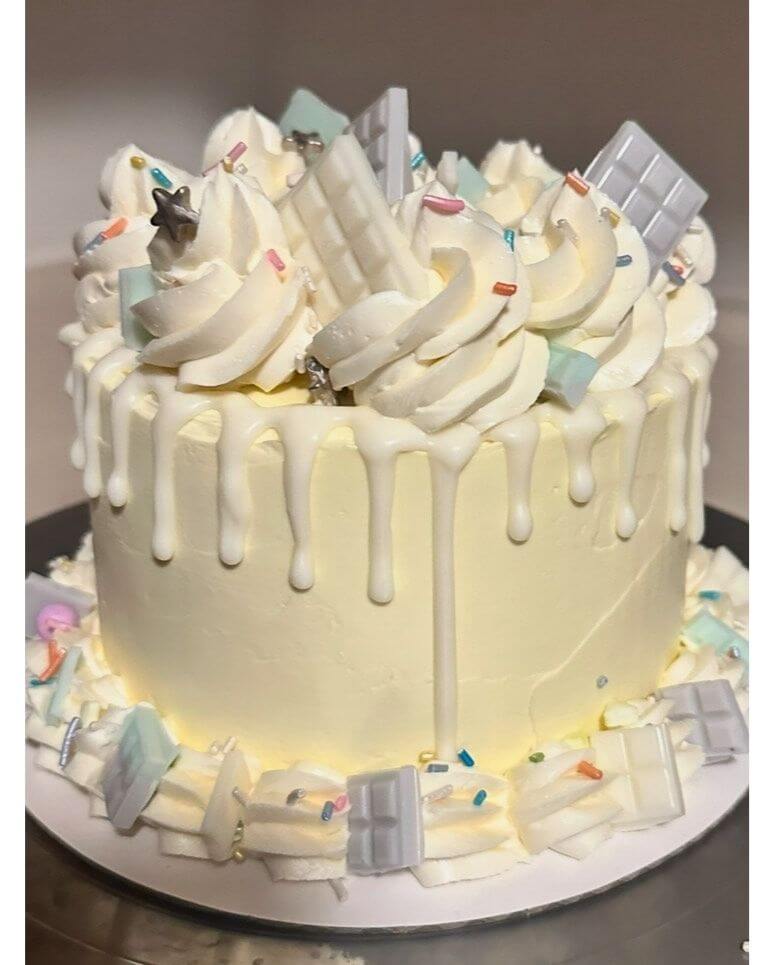 White frosted and decorated layer cake.