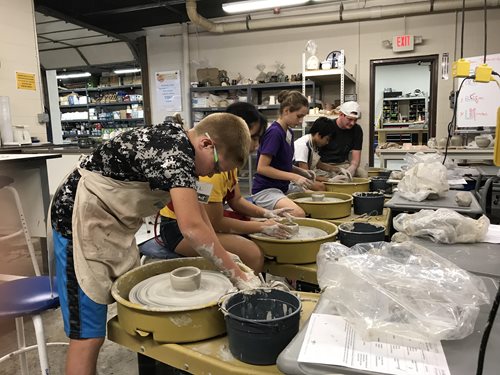 Young students working in ceramics studio