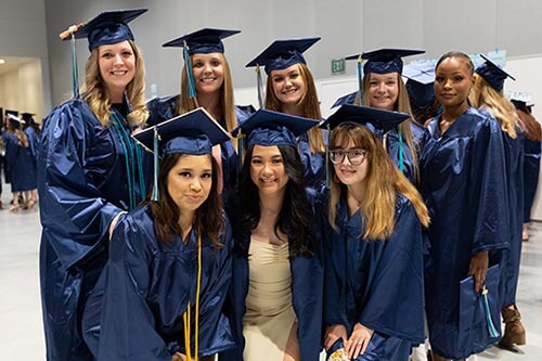 NWTC Graduates stand in their regalia