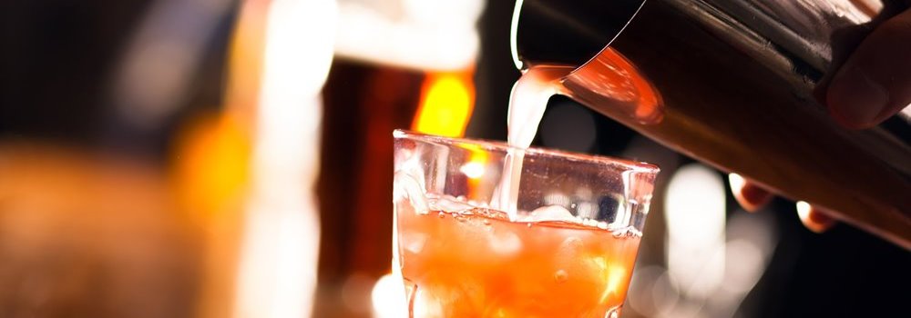 A bartender pouring a drink