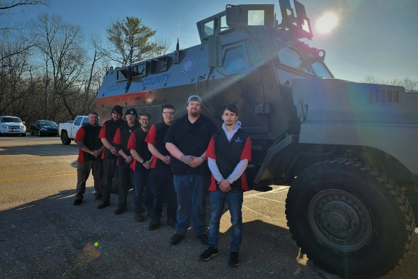 Automotive students with an Oconto Law Enforcement vehicle