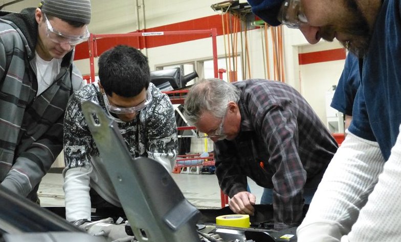 A group of students work together in a lab