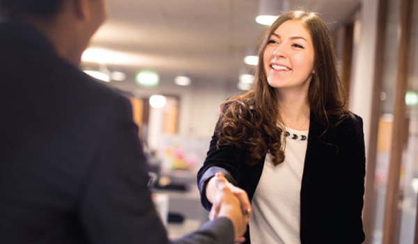 Student worker shakes hands with an employer