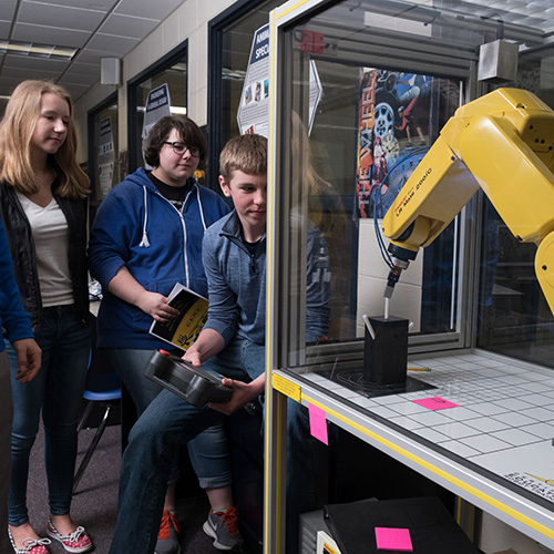TurboCharge Green Bay students work with a robotic arm