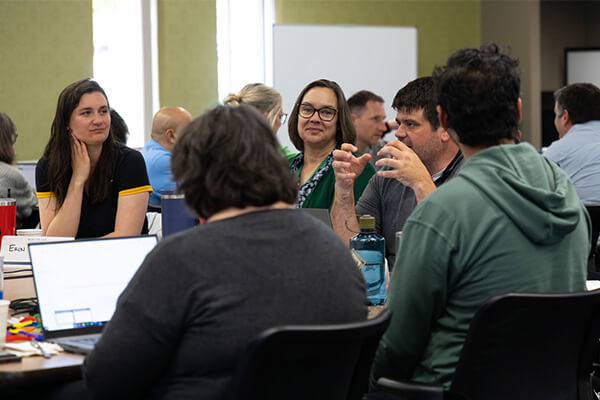 Employees work together at a conference on campus
