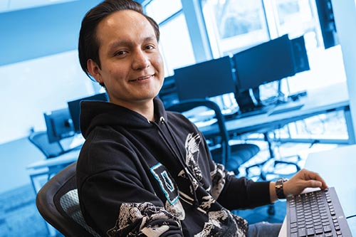 A student sits in a computer lab