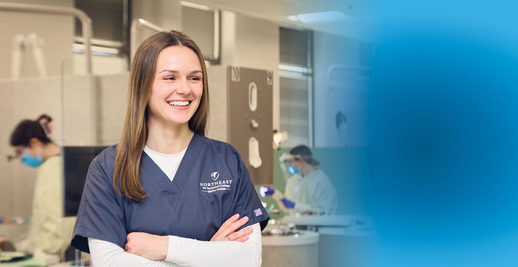 A dental student in their scrubs