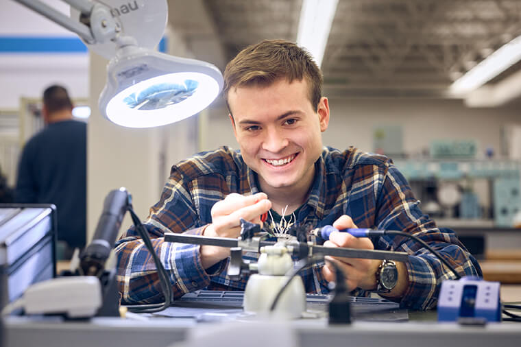 Engineering student works on wiring unit