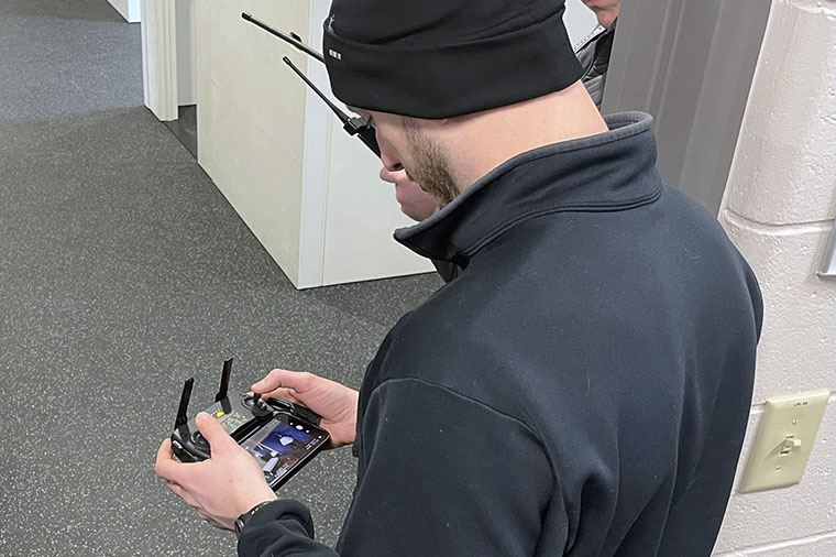 Instructor controls drone using a handheld remote