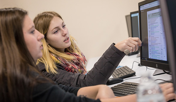 Students work together at a computer