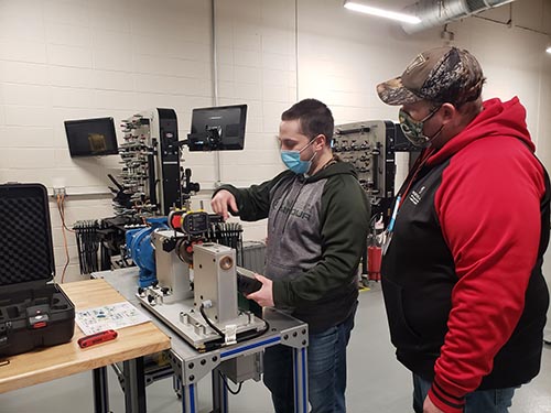 Student and instructor working on electrical equipment