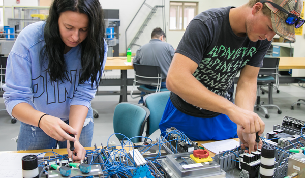 Two students work in advanced manufacturing