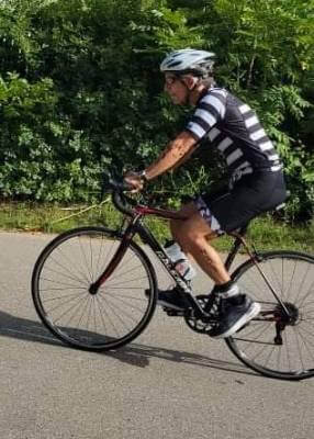 Jerry Lintz on a bicycle, racing during a triathalon