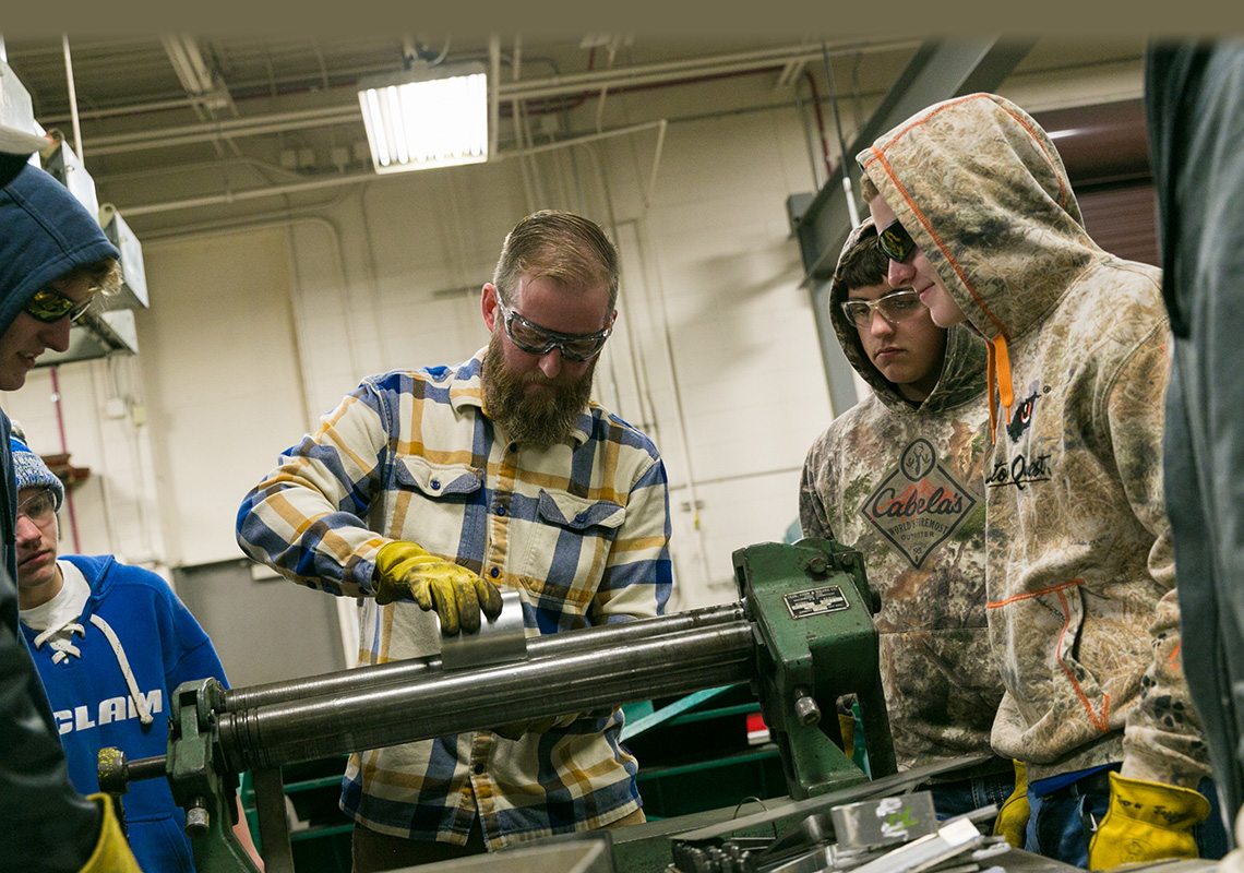 Instructor works with two students