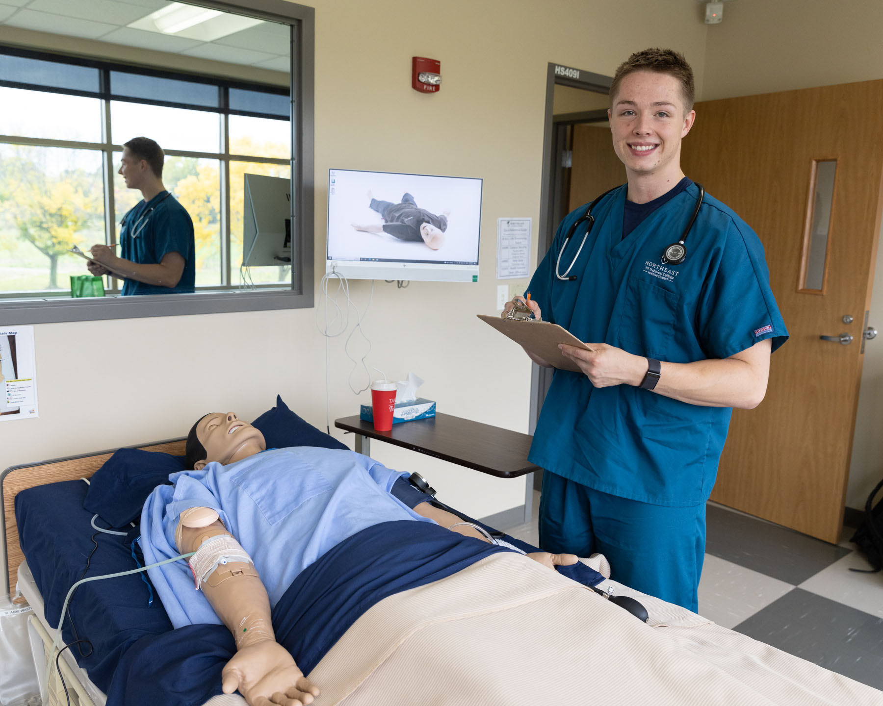 Nurse Austin standing next to patient simulator