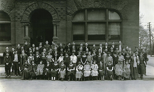 Large group of people from the early 1900s standing in front of the vocational school