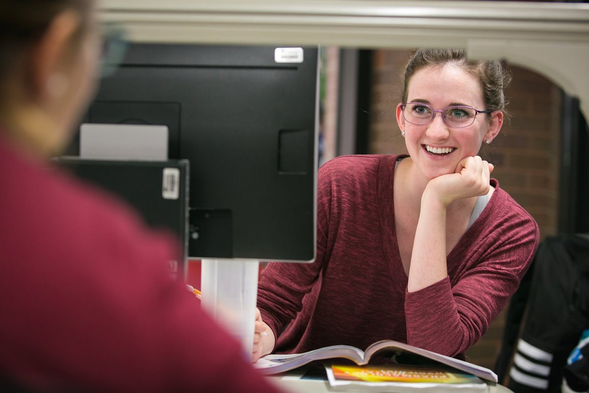 A student wearing a hat works on CAD