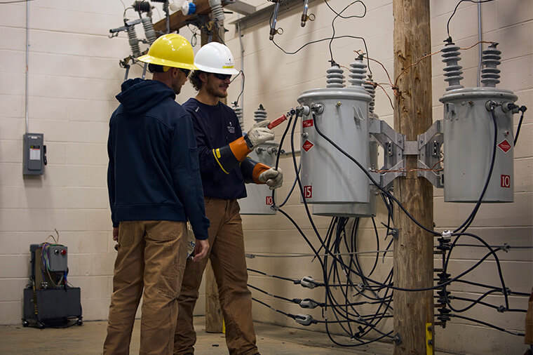 NWTC students work on a simulation of utility poles