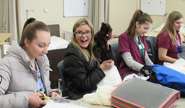 Nursing assistant students work together on a project