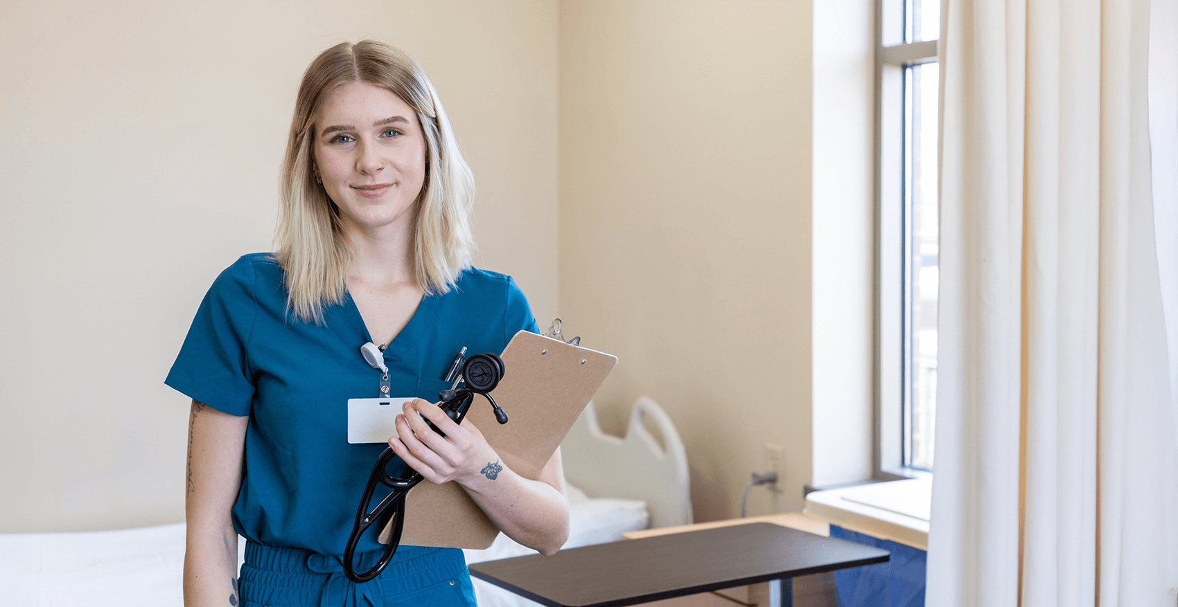 A nursing student in their scrubs