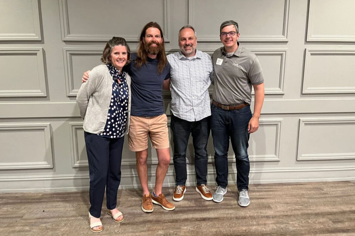Matt Kaczmarek stands with members of a speaker panel