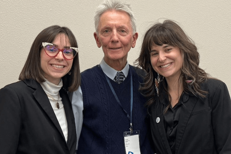 Two women and a man posing for a photo.