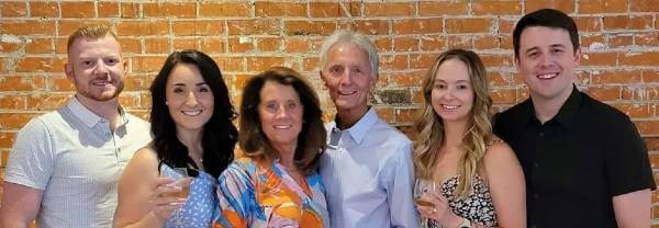 Jerry Lintz stands with his wife and children