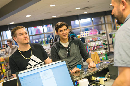 Students buy textbooks in the bookstore