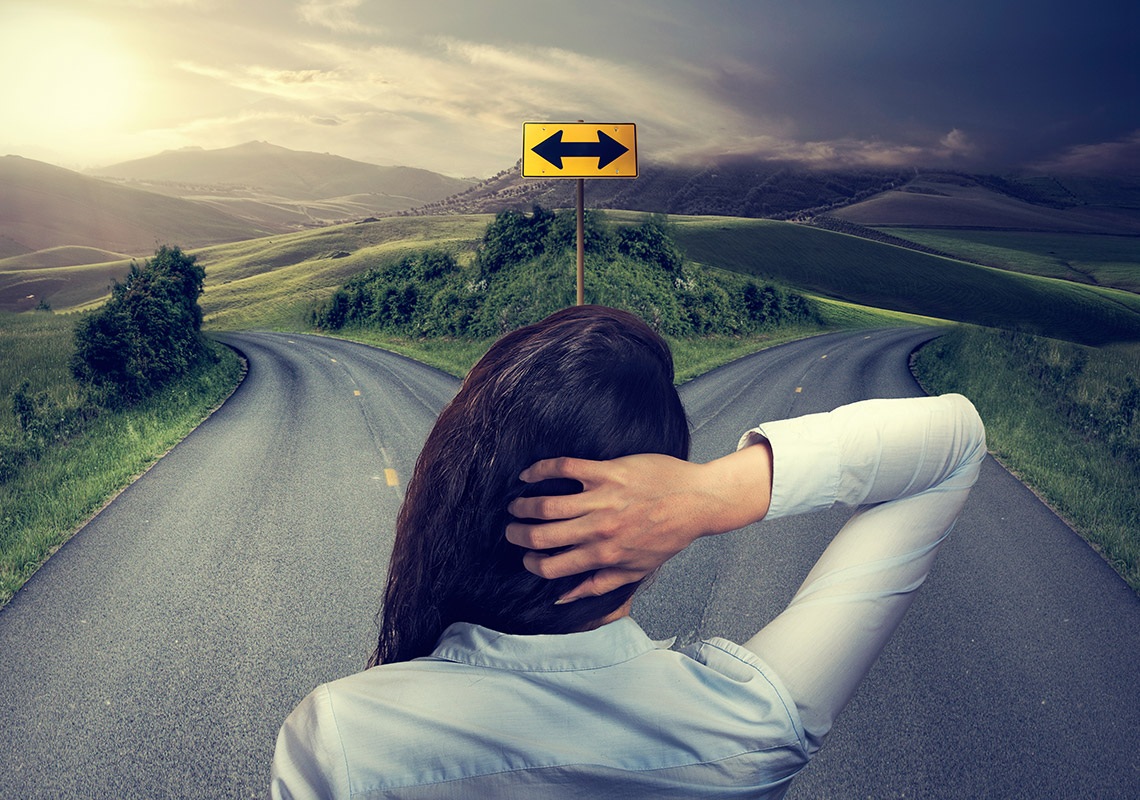 A student stands at a crossroad