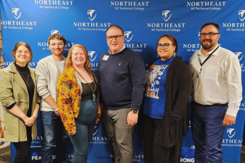 Students standing in front of NWTC banner