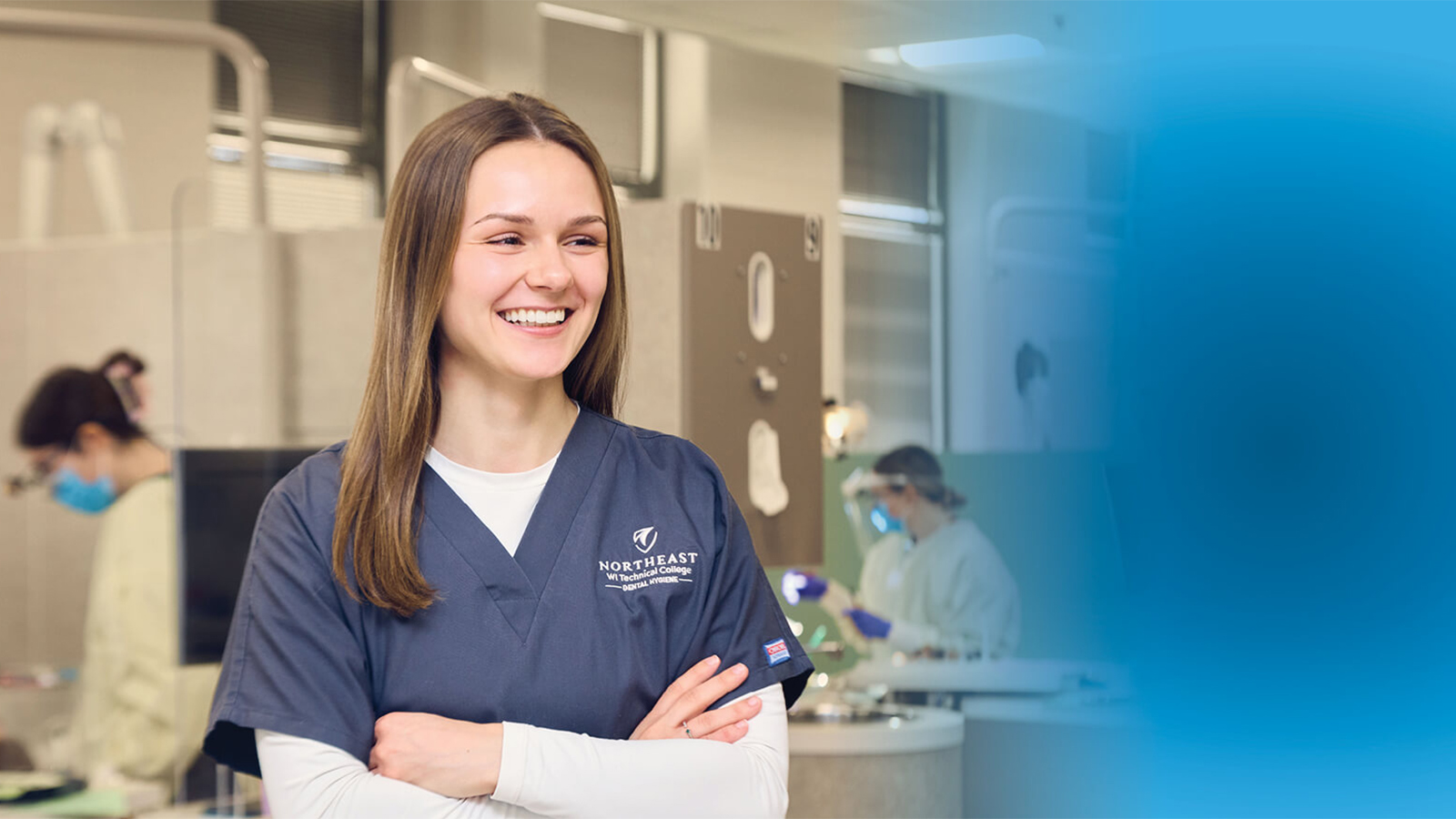 A dental student in their scrubs