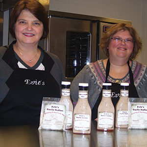 Two kitchen students pose with their product