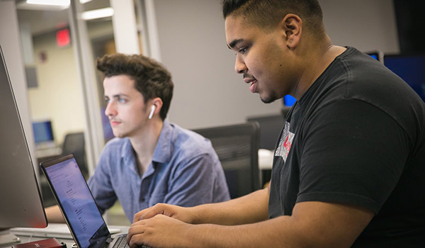 Two students work side by side