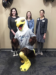 Eagle posing for a picture with others in the background.