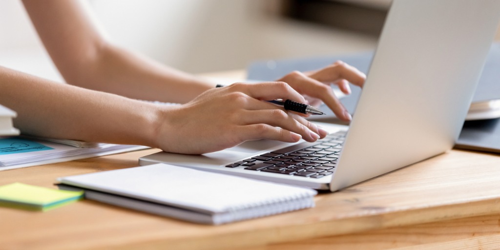 Up-close of person's hands taking online assessment