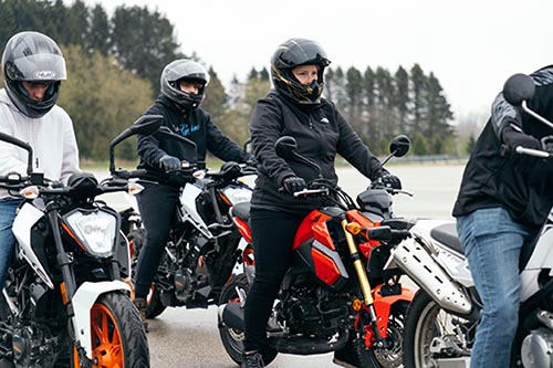 Students sitting on  motorcycles