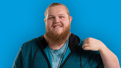 A man with a beard smiles at the camera