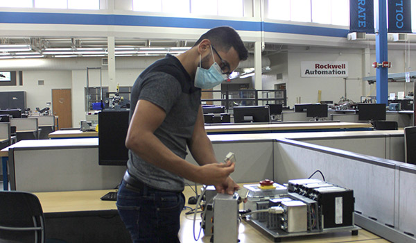 Young male student works on a mobile modular unit