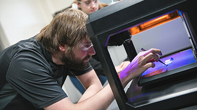 Student 3D printing an item