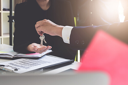 Person handing over house Keys