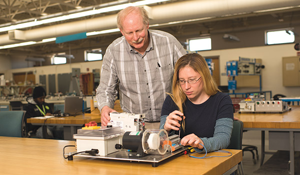 A student and teacher work together on a mobile modular system