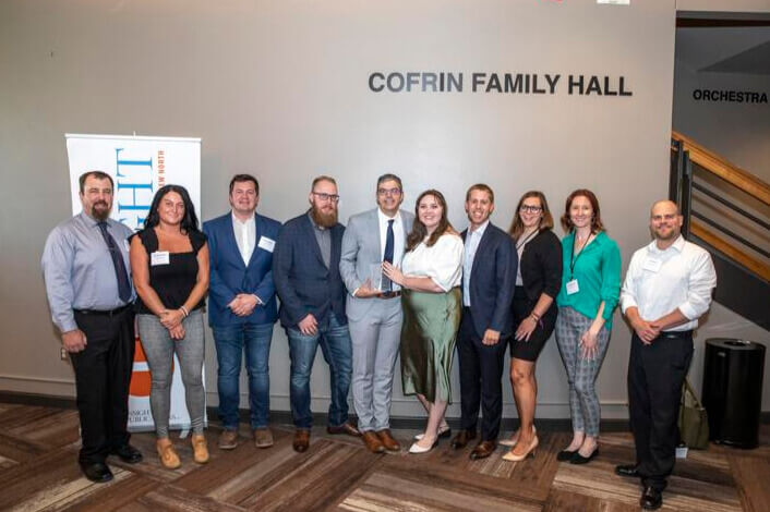 Matt Kaczmarek standing with family and colleagues at 40 Under 40 award ceremony