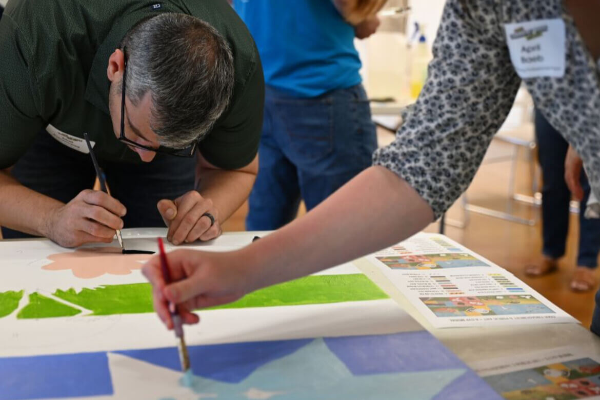 Matt Kaczmarek paints during a volunteer art project