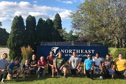 Students pose in front of NWTC sign