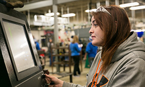Female student works in a trades lab